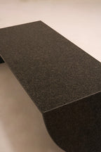 Angled top perspective showing surface sheen and black stone material quality