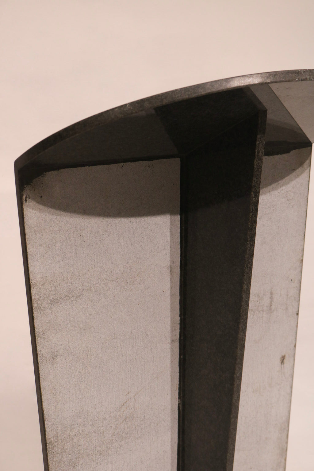 Underside view showing structural support and hollow construction of stone table