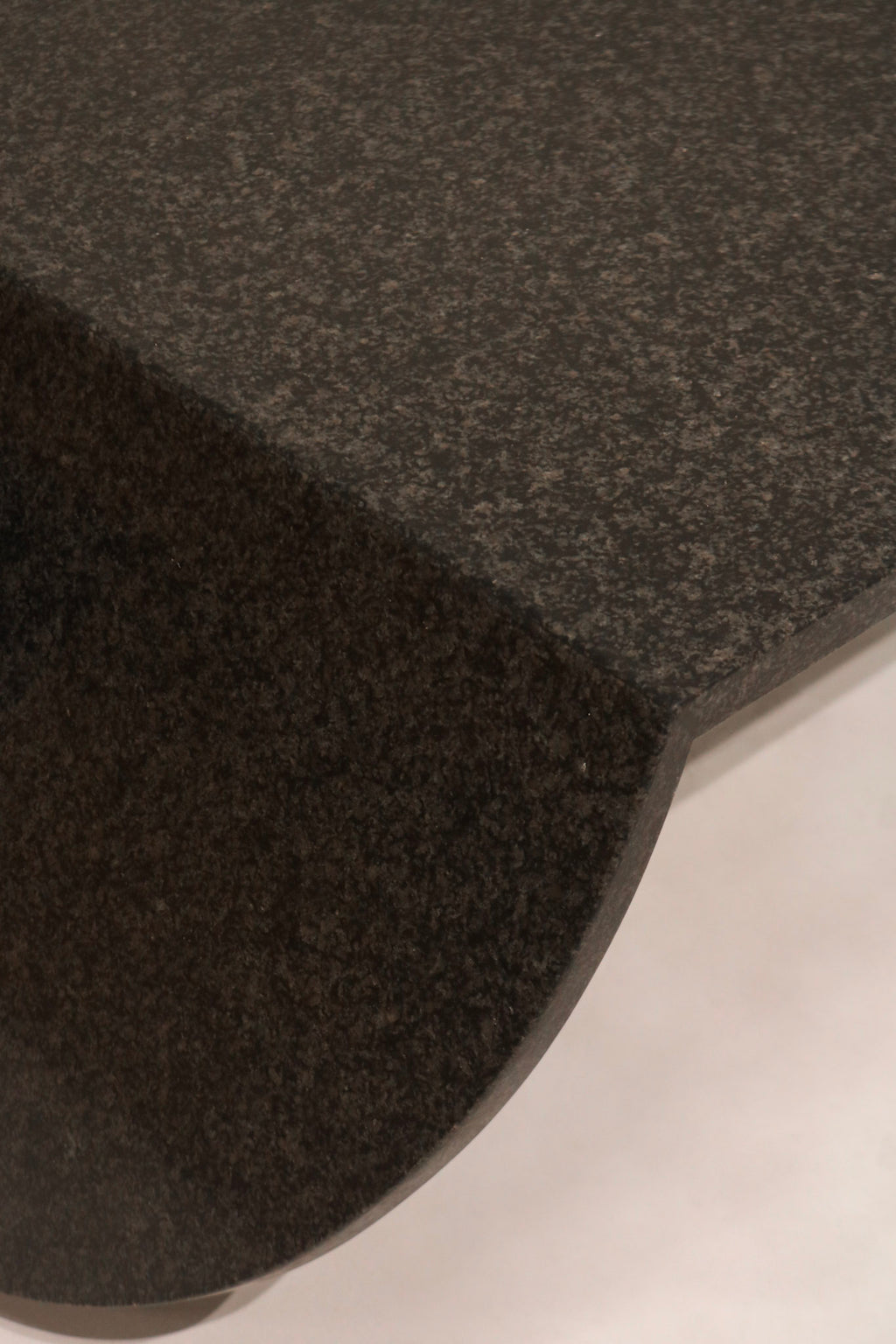 Close-up of table top edge showing polished finish and stone thickness