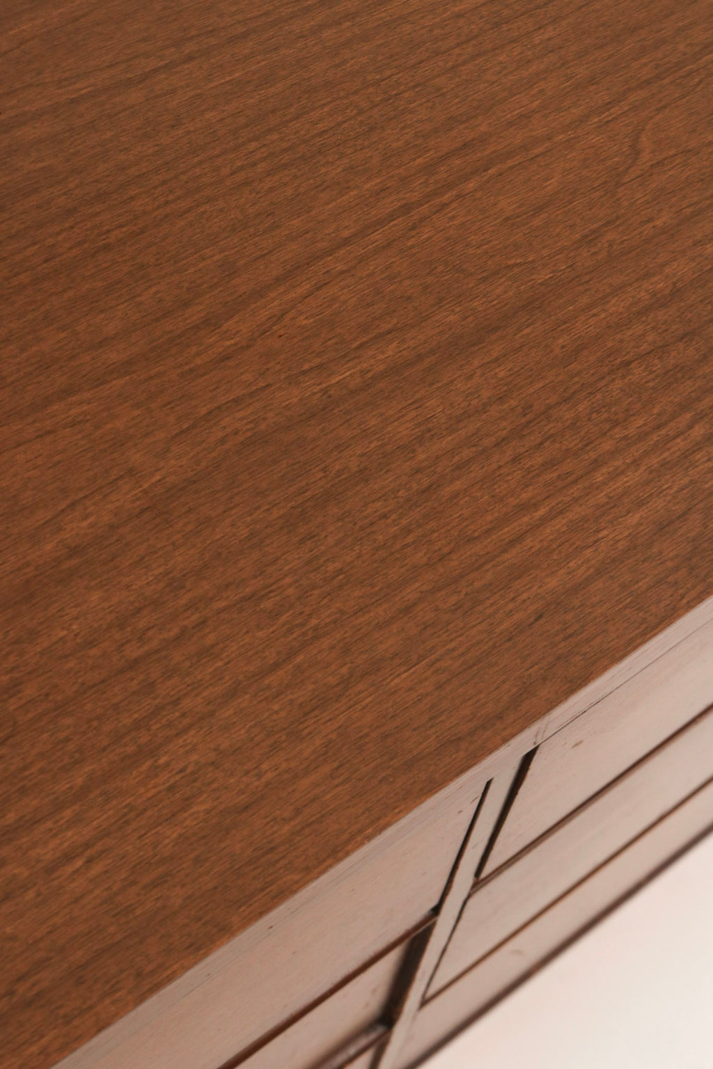 Close-up of tapered wooden leg base characteristic of mid-century style