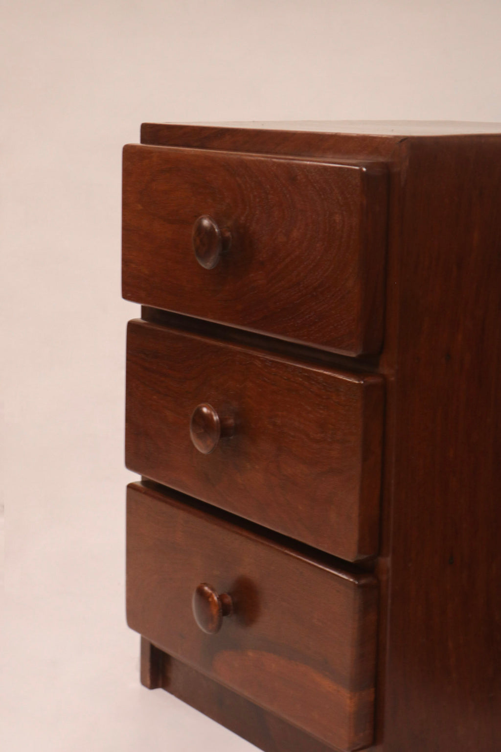Front view of the three-drawer stack highlighting the walnut grain pattern