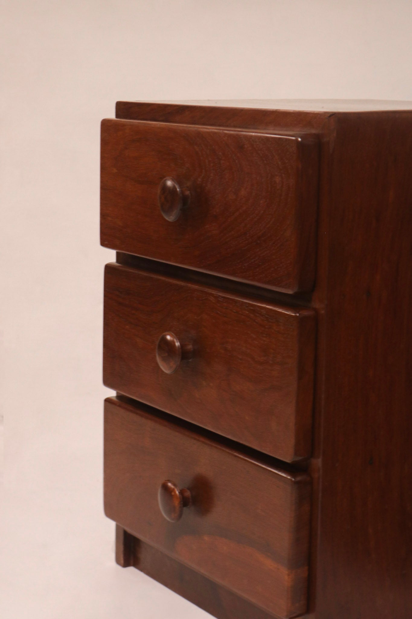 Front view of the three-drawer stack highlighting the walnut grain pattern