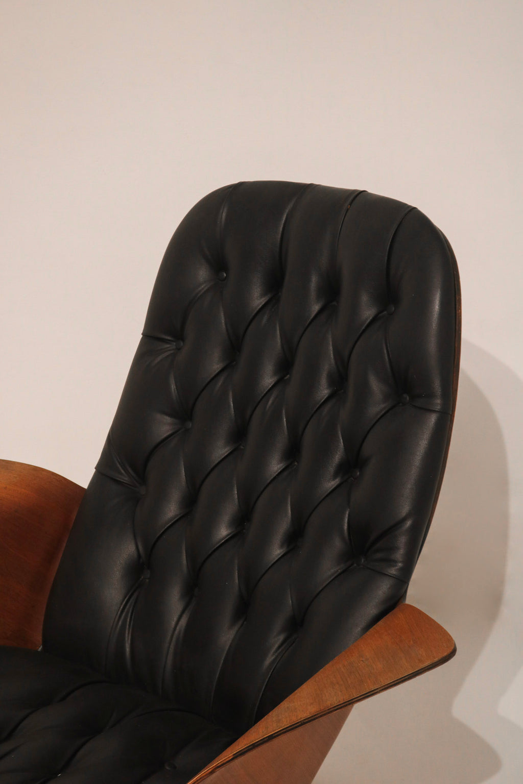 Three-quarter view of the chair and ottoman set arrangement