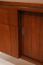 Close-up of the top corner showing the junction of walnut and chrome leg