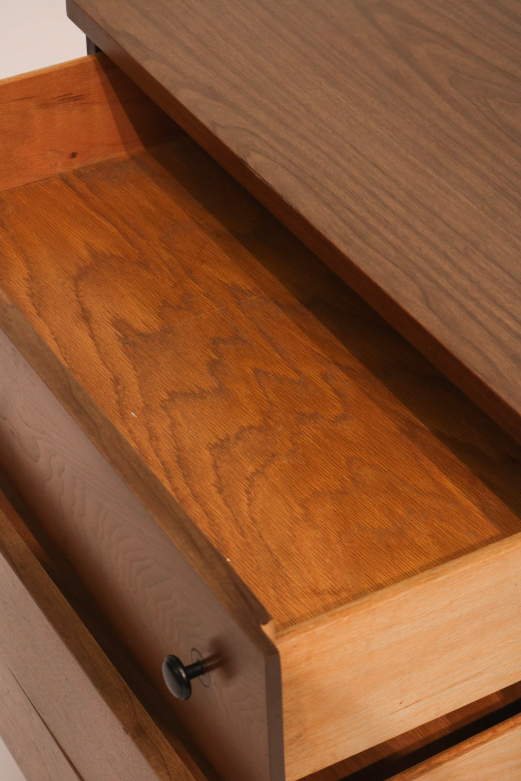 Close-up of top corner edge showing walnut finish and condition