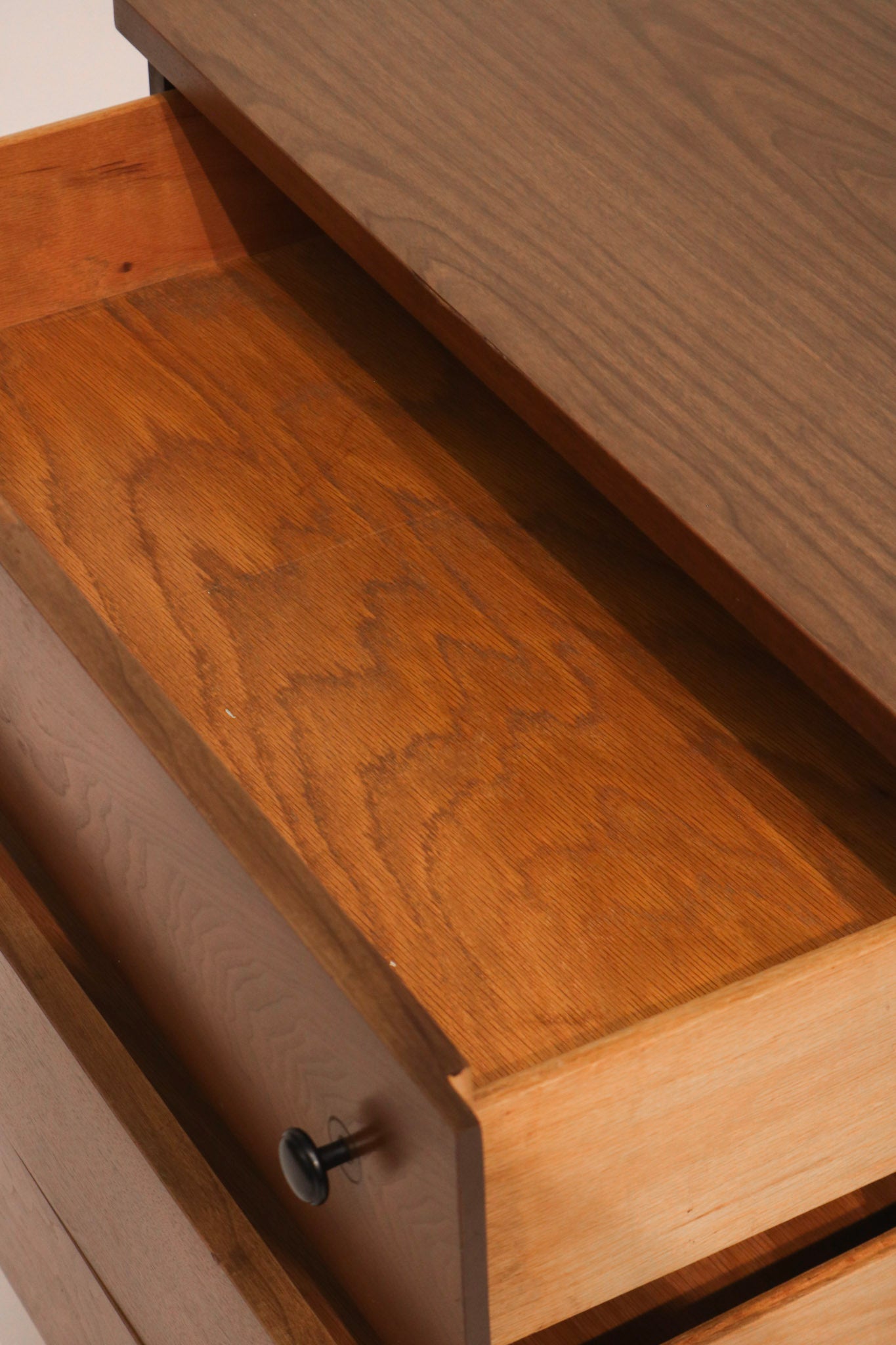 Close-up of top corner edge showing walnut finish and condition