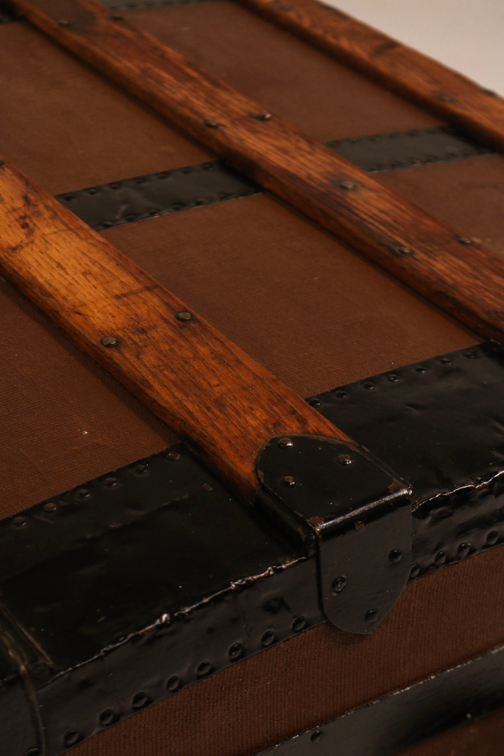 Top corner detail showing protective iron bracket and wood patina