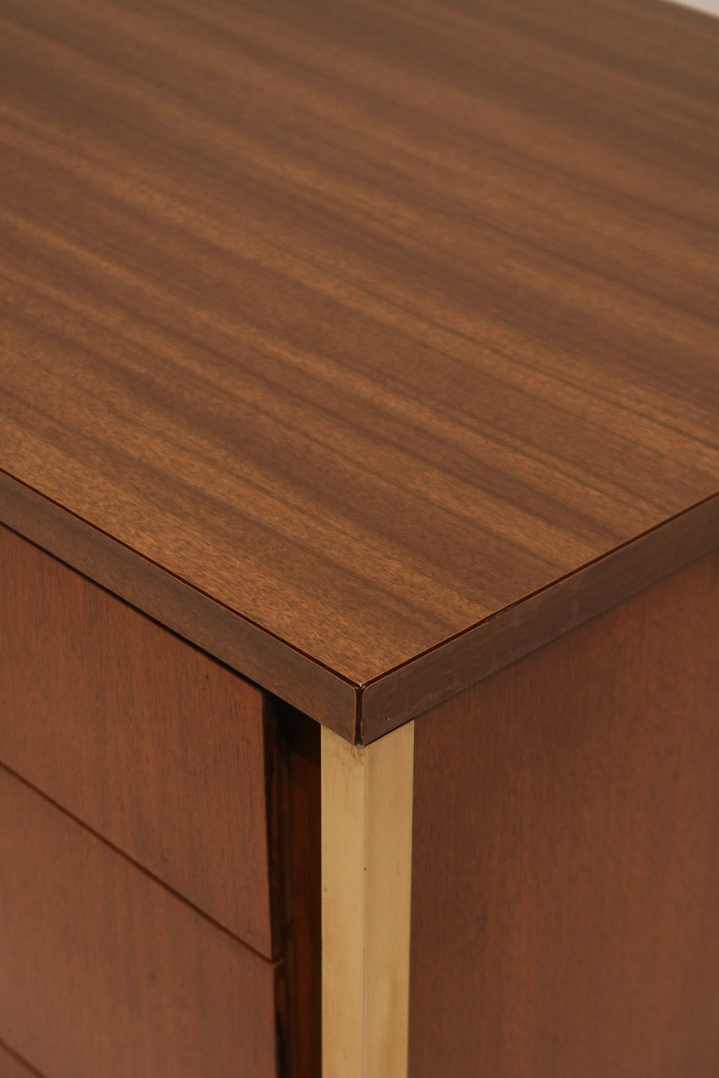 Close-up of top corner edge showing walnut finish and gold trim accent