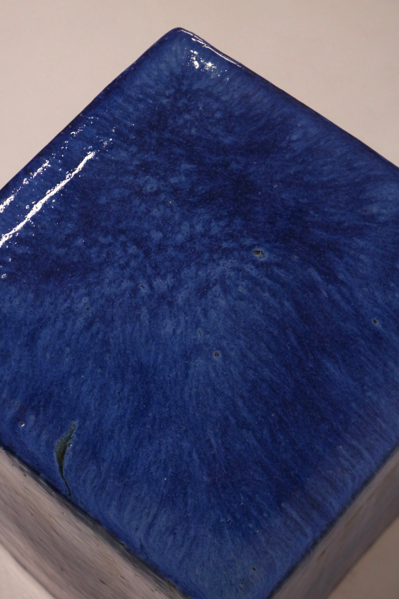 High angle view showing rich blue glaze texture and cube geometry