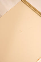 Detail of top surface showing cream lacquer finish and minor mark