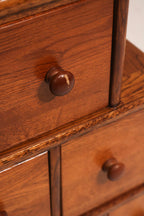 Top tier panel construction showing joinery and solid oak grain detail