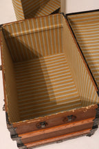 Interior view of open trunk showing original striped lining and depth