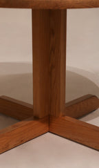 Underside view of base cross structure on vintage oak round dining table
