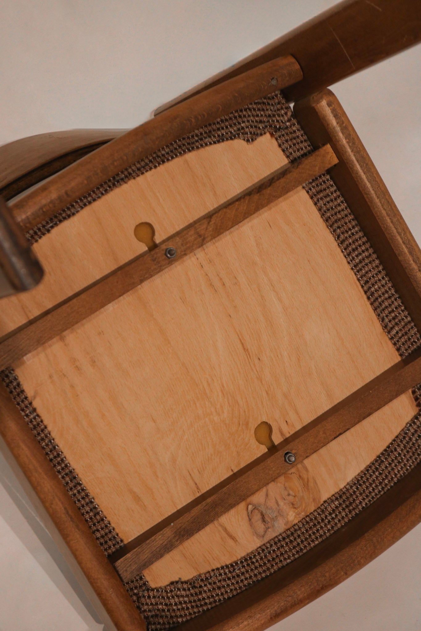 Underside view of chair showing seat frame construction and corner blocks