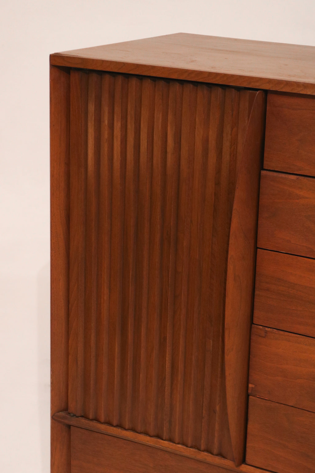 Close-up of the sculptural vertical wood slats on the left door panel