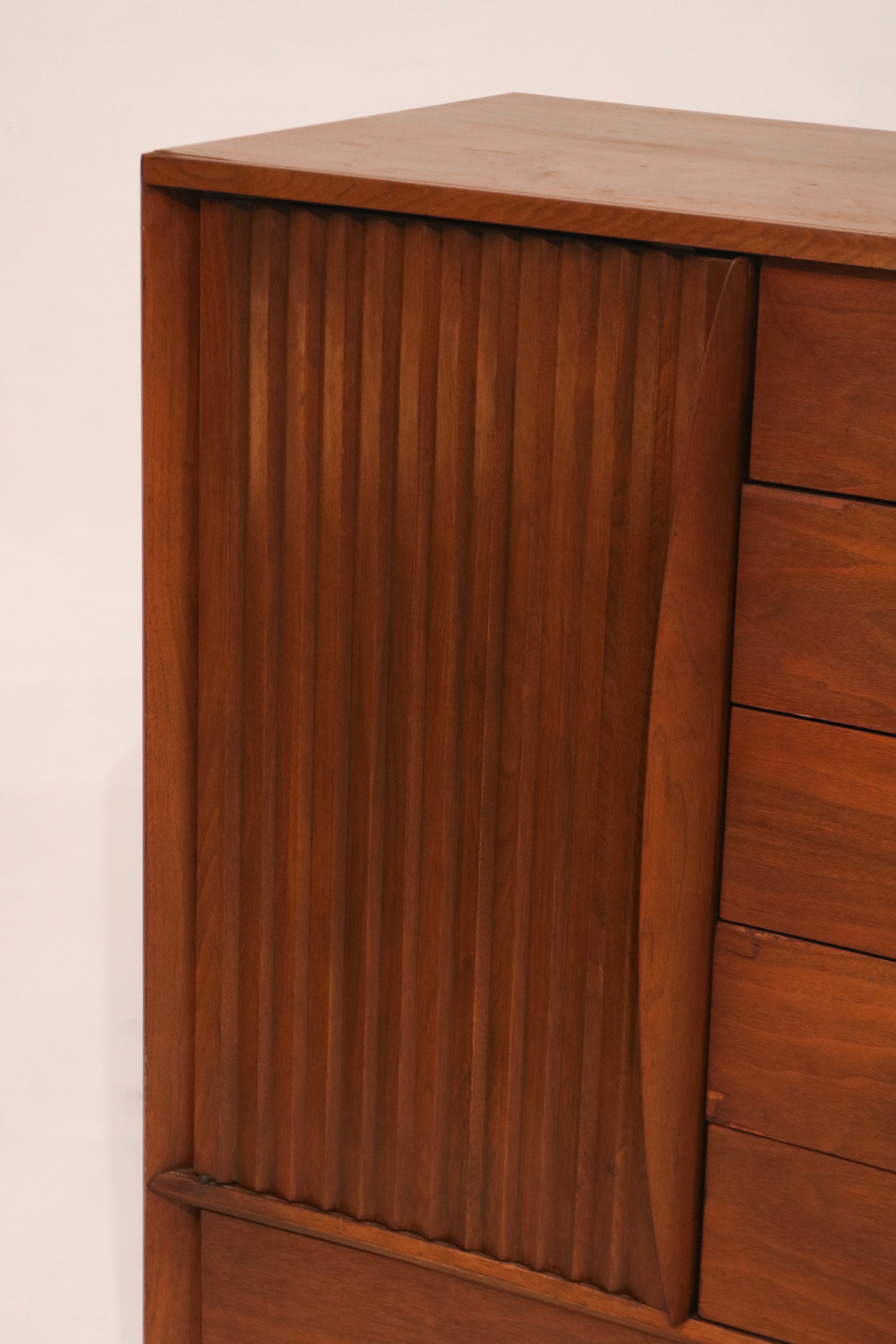 Close-up of the sculptural vertical wood slats on the left door panel