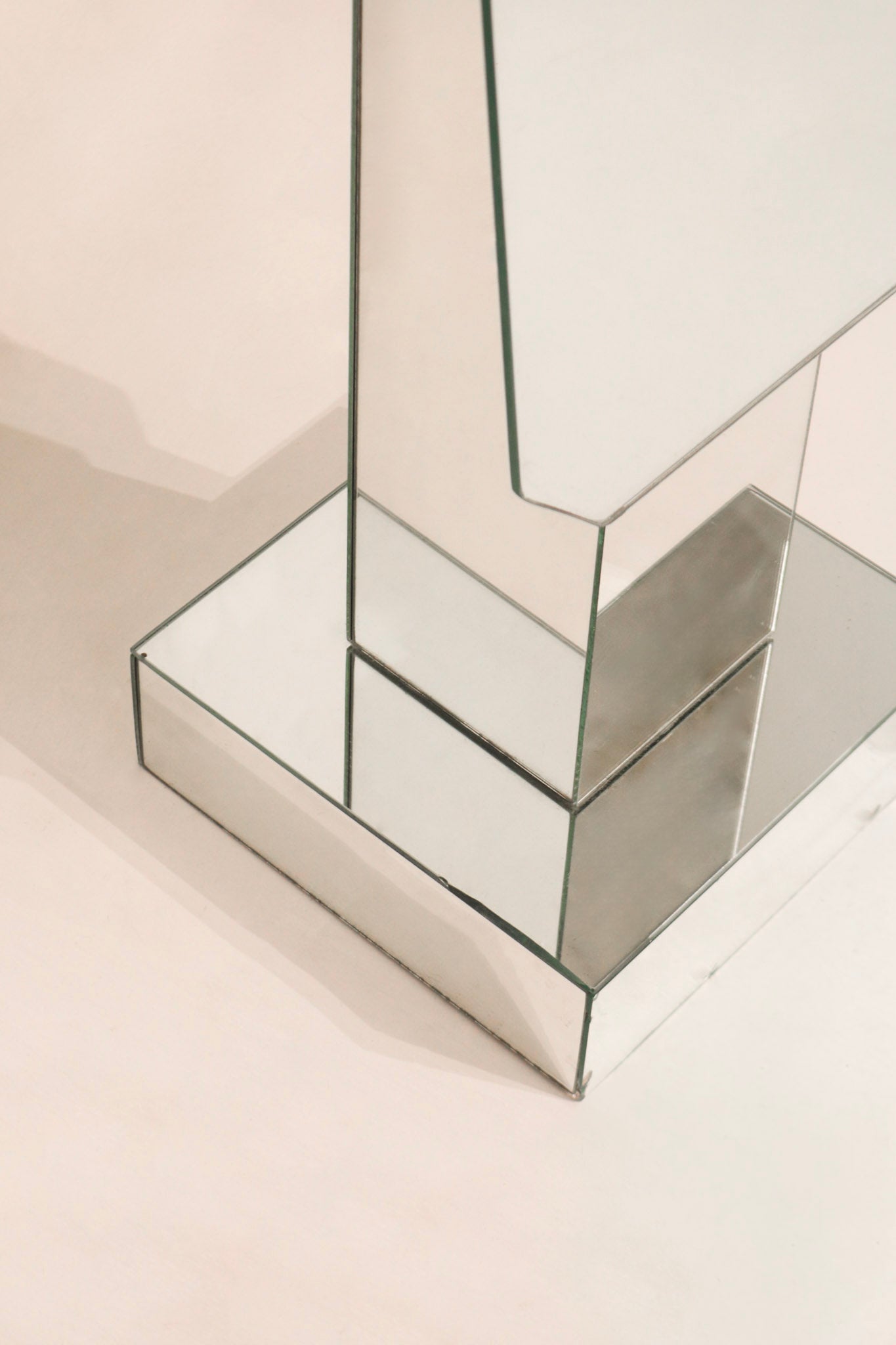 Upper section detail postmodern standing mirror showing geometric mirrored construction