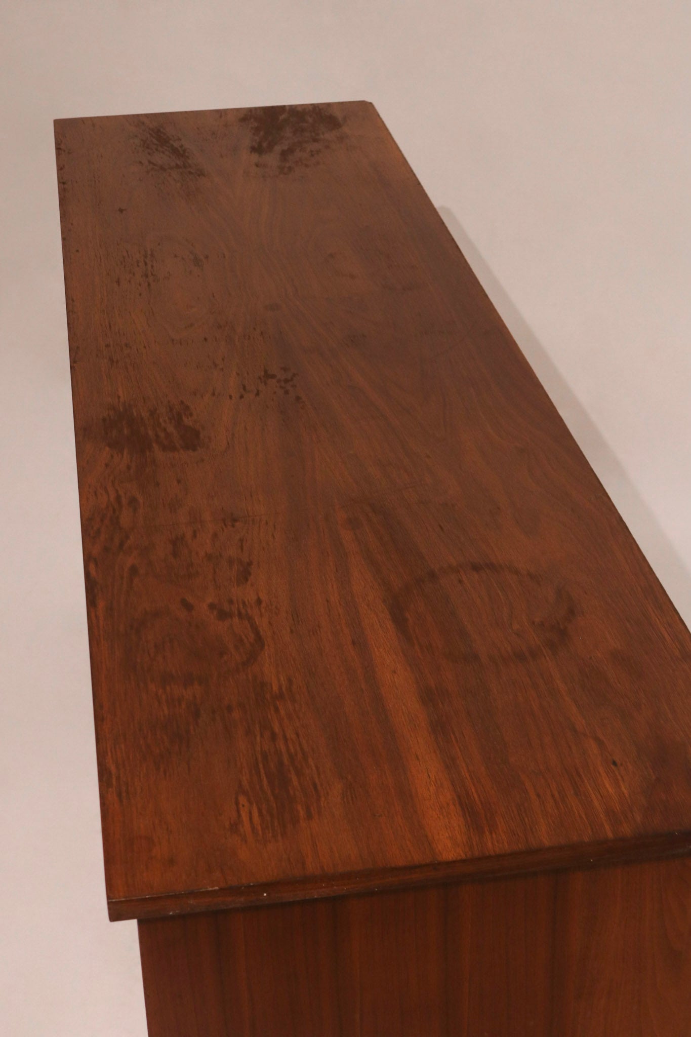 Top view of walnut dresser surface highlighting wear marks and wood grain