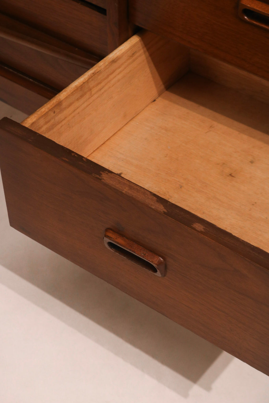 Angled view of walnut top surface with visible wear and finish texture