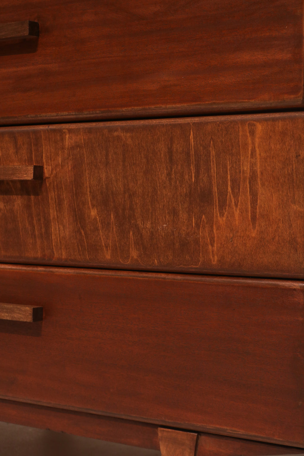 Close-up of walnut wood grain texture on the drawer fronts