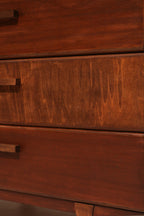 Close-up of walnut wood grain texture on the drawer fronts