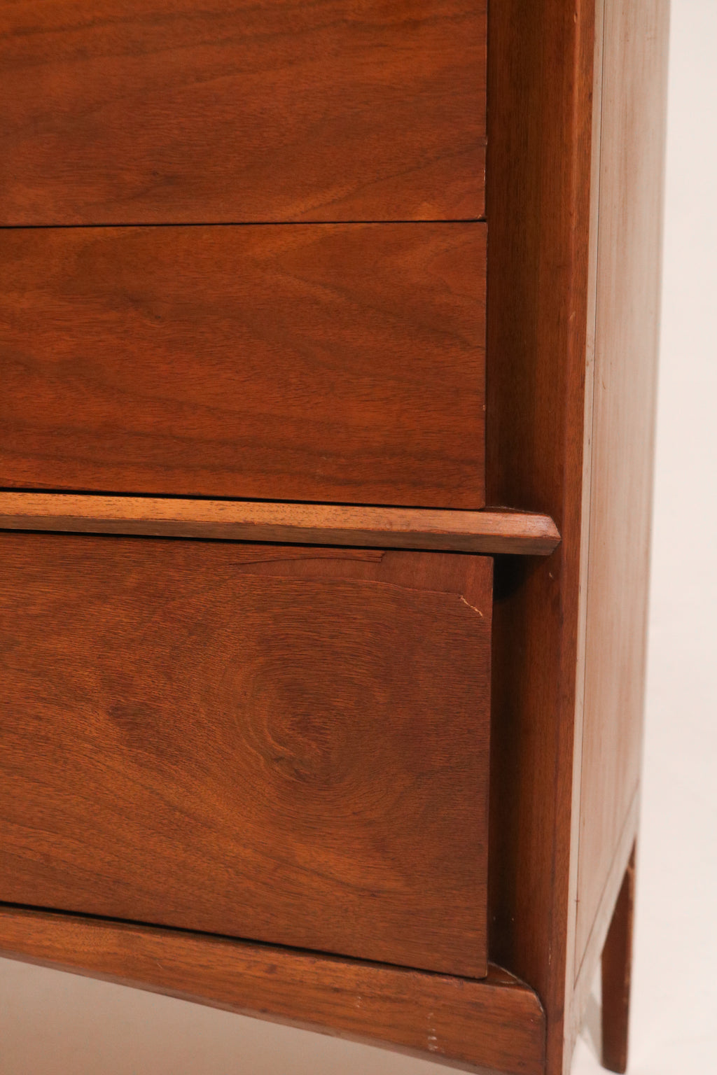 Close-up of the subtle wood handle detail on the cabinet door
