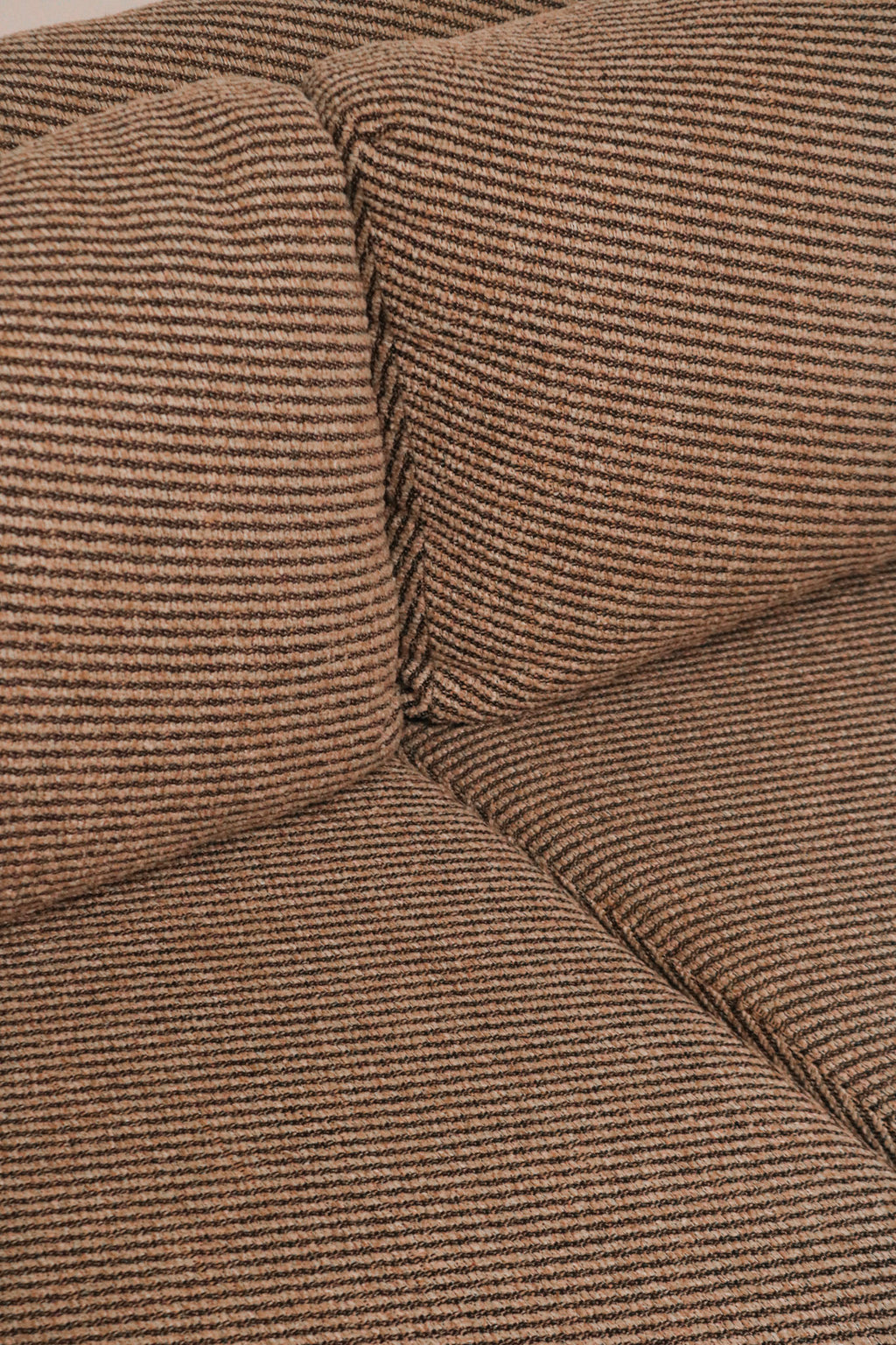 Macro view of the woven fabric texture pattern in a neutral tone